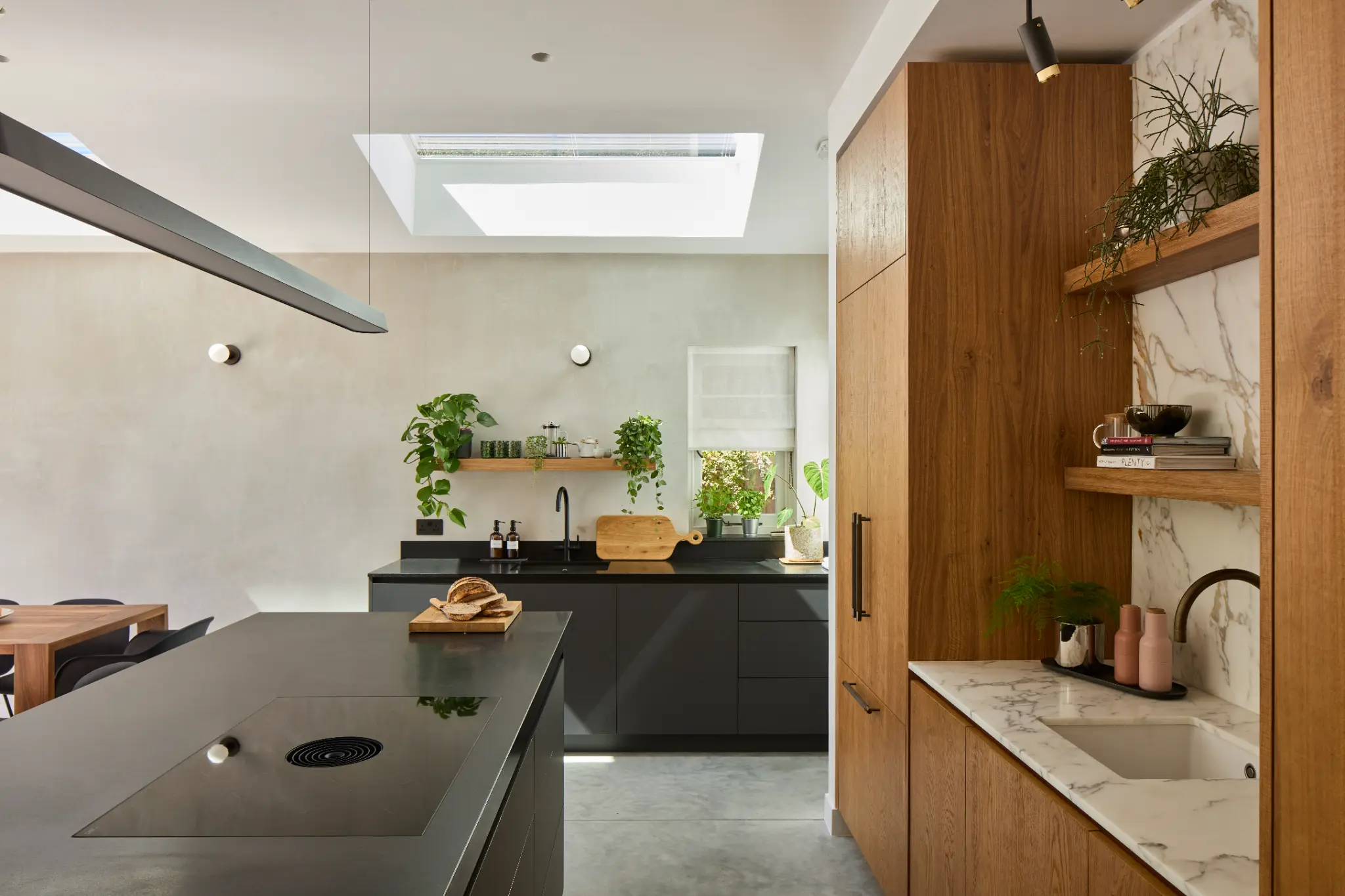 Daylit kitchen with trailing plants and timber joinery supporting sustainable materials